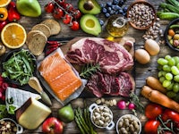 a variety of foods are arranged on a wooden table